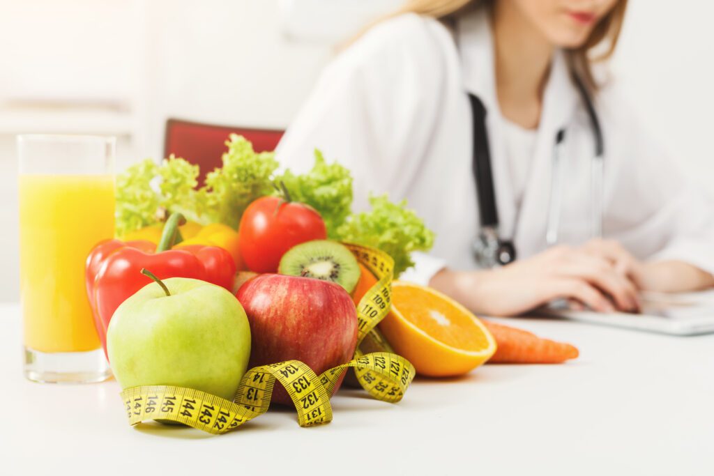 nutritionist-desk-with-fruit-and-measuring-tape-2021-08-26-16-32-19-utc-1024x683